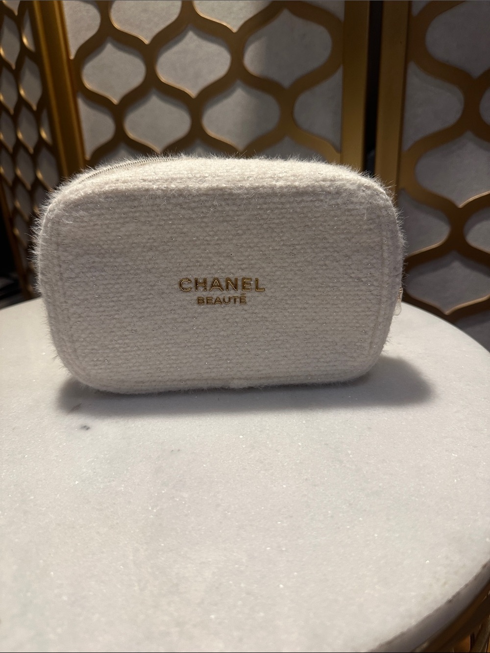 CHANEL cream boucle cosmetic pouch with gold logo